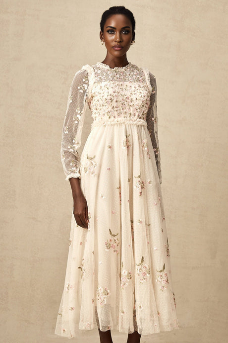 A elegant midi dress with floral embroidery on tulle fabric designed by Celine featuring delicate floral patterns on a sheer overlay
