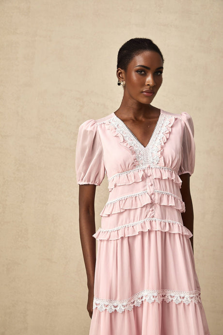 A feminine pink midi dress with ruffled tiers and a flowy silhouette named Amelie