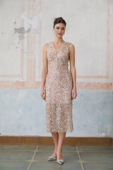 A fitted midi dress with an embellished flower motif featuring a Marguerite daisy design