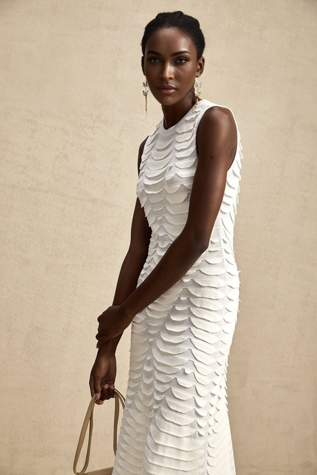 A floorlength snakepattern dress with a fitted bodice and flared skirt featuring godet inserts creating a flowing silhouette