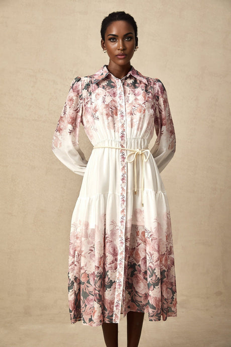 A floral patterned midi dress with lantern sleeves and a design inspired by the Carina style featuring a vibrant print on a light background