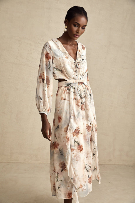 A floral print midi dress with an open waist design featuring a colorful pattern on a light background The dress has a flowing silhouette and appears to be made from a lightweight fabric suitable for warm weather