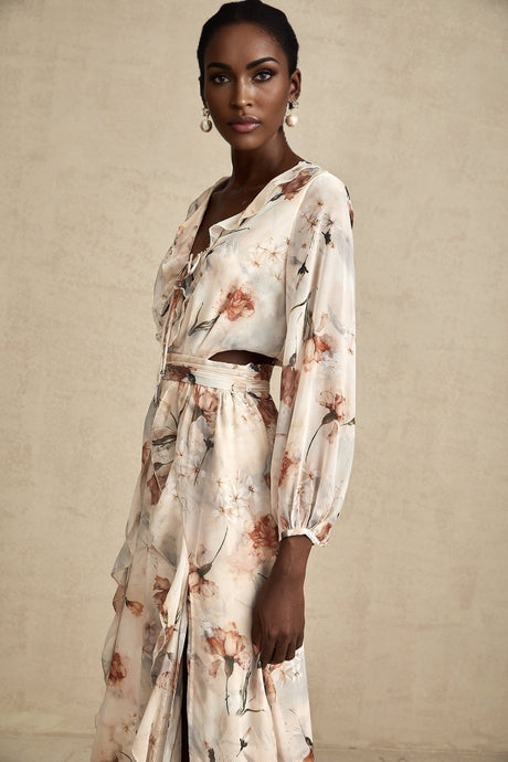 A floral print midi dress with an open waist design featuring a colorful pattern on a light background The dress has a flowing silhouette and appears to be made of a lightweight fabric suitable for warm weather