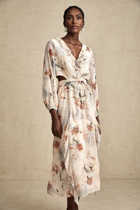 A floral print midi dress with an open waist design featuring a colorful pattern on a light background The dress has a flowing silhouette and appears to be made of lightweight fabric suitable for warmer weather
