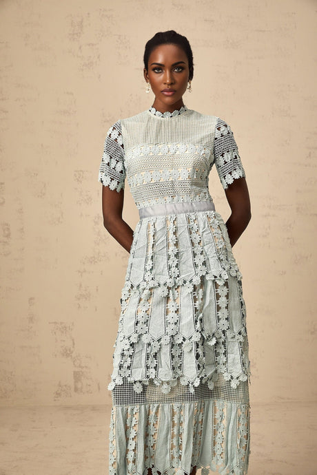 A green midi dress with floral embroidery details featuring a design inspired by ocean themes
