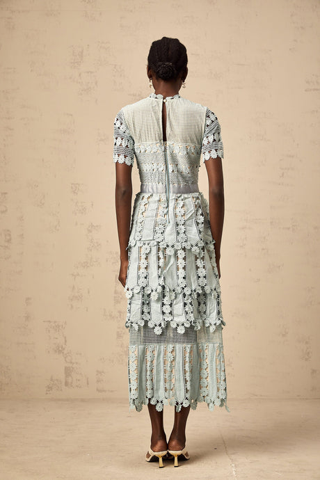 A green midi dress with floral embroidery details featuring a design inspired by ocean themes