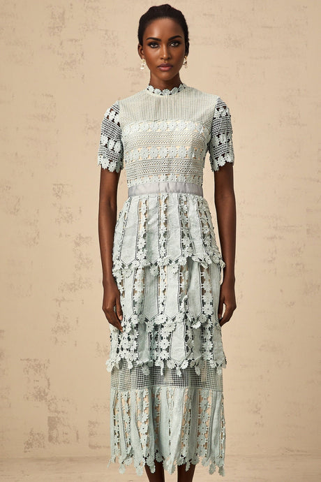 A green midi dress with floral embroidery patterns featuring a design inspired by the ocean