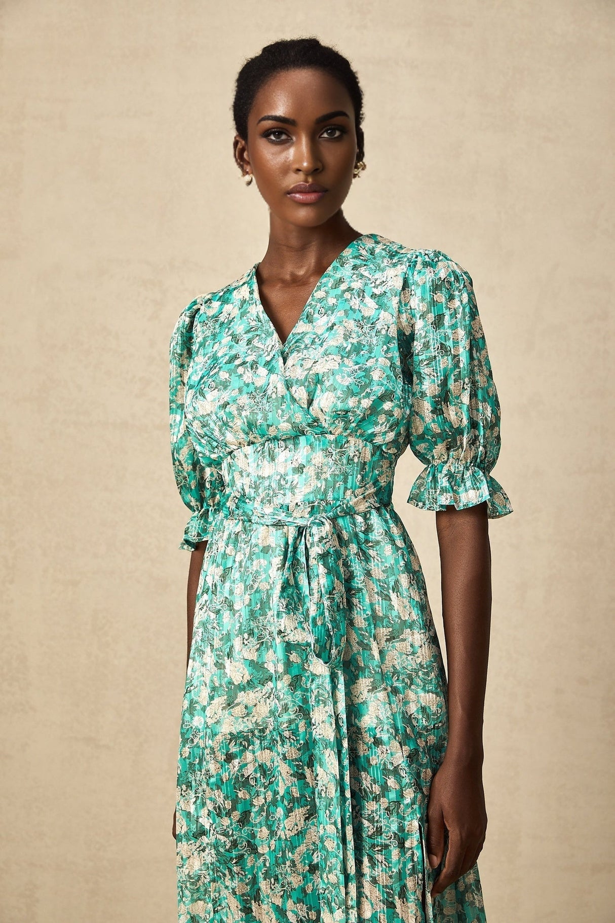 A green midi dress with floral print and high slit featuring the Alisa design
