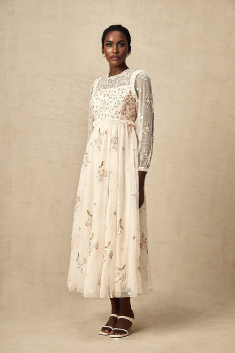 A long tulle midi dress with floral embroidery by Celine featuring delicate floral patterns on sheer fabric and a flowing silhouette