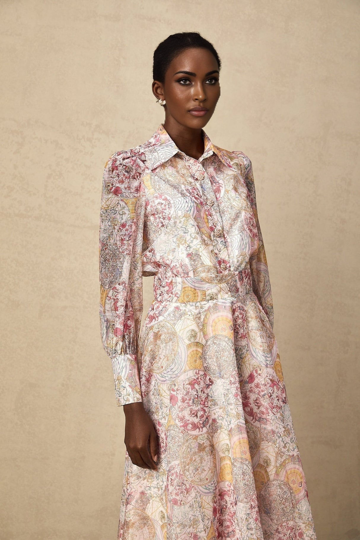 A matching set consisting of a cherry pink shirt and skirt both featuring a pattern print design