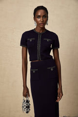A matching set consisting of a ribbed knit top and skirt with embellishments called Aida The top and skirt feature a textured knit pattern and decorative details The set is designed to be worn together as a coordinated outfit