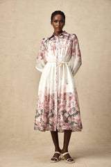 A midi dress with a floral print pattern featuring lantern sleeves and a design called Carina