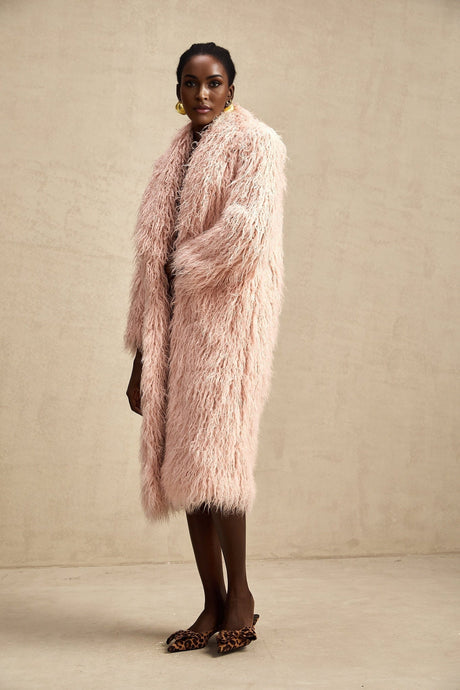 A pink faux fur coat with an open front design worn by a model against a plain background
