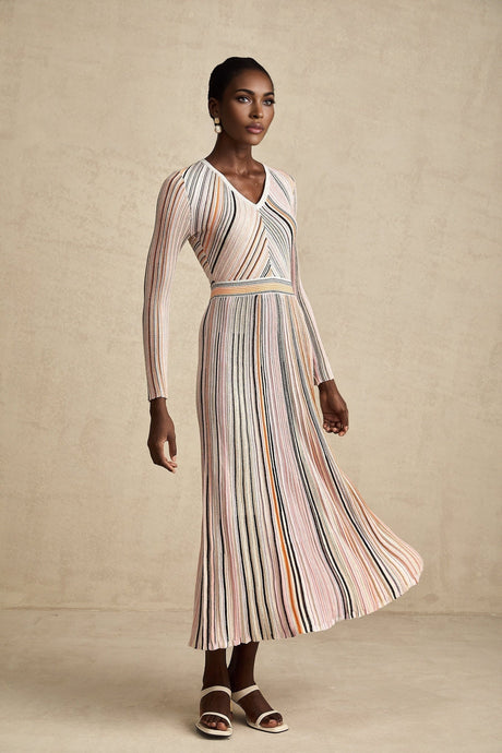 A pink metallic midi dress with pleated design named Mathilde featuring a shimmering finish and midlength hemline