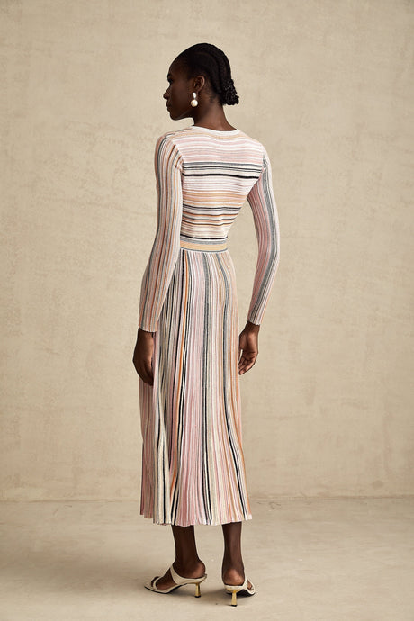 A pink metallic midi dress with pleated fabric named Mathilde featuring a shimmery finish and flowing design