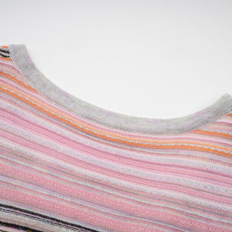 A pink metallic pleated midi dress with a feminine silhouette named Mathilde shimmering in the light with its lustrous fabric and flowing pleats