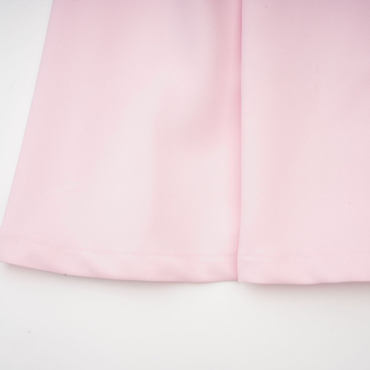 A pink midi dress with a bow detail and crystal accents inspired by the Cassiopeia constellation