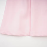 A pink midi dress with a bow detail and crystal accents inspired by the Cassiopeia constellation