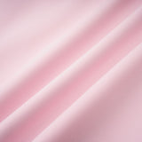 A pink midi dress with a crystalaccented bow and a silhouette inspired by the Cassiopeia constellation