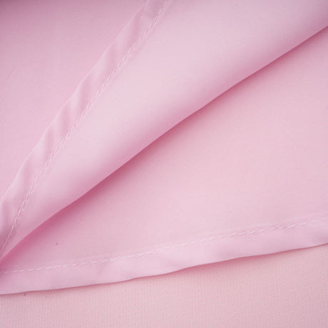 A pink midi dress with a crystalaccented bow design inspired by the Cassiopeia constellation featuring a feminine silhouette and elegant details