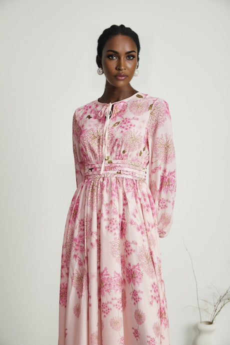 A pink midi dress with a floral print pattern called Yvette