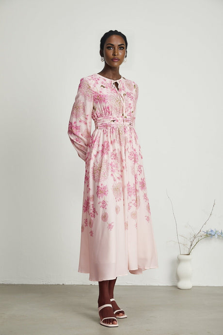 A pink midi dress with a floral print pattern featuring a feminine Yvette design