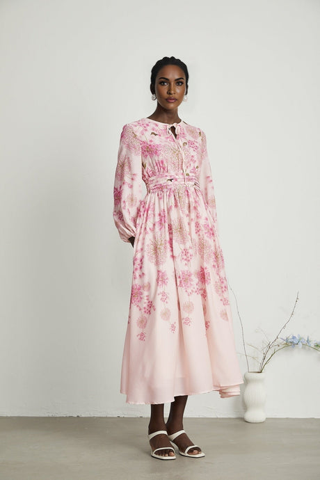 A pink midi dress with a floral print pattern featuring the Yvette design