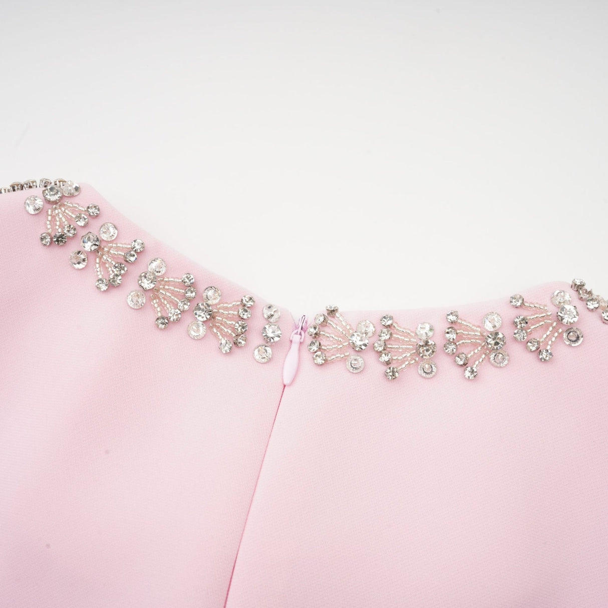 A pink midi dress with a large bow accent and crystal embellishments inspired by the Cassiopeia constellation
