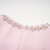 A pink midi dress with a large bow accent and crystal embellishments inspired by the Cassiopeia constellation