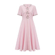 A pink midi dress with a large bow detail adorned with crystal accents named Cassiopeia