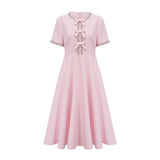 A pink midi dress with a large bow detail adorned with crystal accents named Cassiopeia