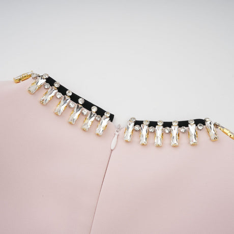 A pink midi dress with crystal embellishments and colorblocked design featuring the name Anais