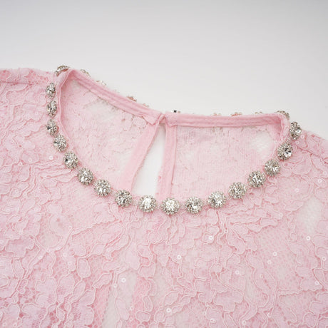 A pink midi dress with floral embroidery and lace detailing featuring embellishments and a feminine silhouette