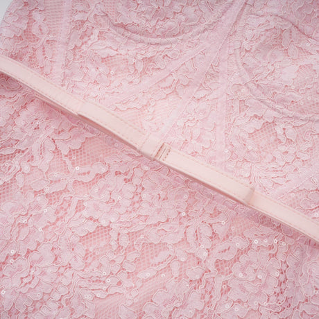 A pink midi dress with floral embroidery and lace details featuring embellishments and a delicate feminine design