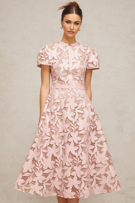 A pink midi dress with guipure lace detailing featuring a delicate floral pattern and a feminine silhouette