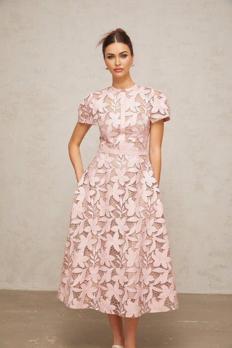 A pink midi dress with intricate guipure lace detailing named Verane
