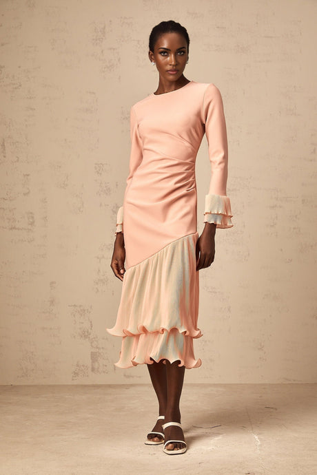 A pink midi dress with ruffled trim and panel details featuring a feminine silhouette and flowy design