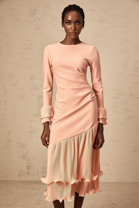 A pink midi dress with ruffled trim and paneled design featuring a flared silhouette and feminine details