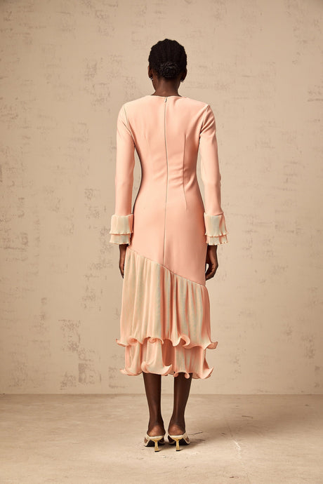 A pink midi dress with ruffled trim and paneled design featuring a flowy silhouette and feminine details