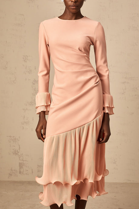 A pink midi dress with ruffled trim and paneled design featuring a flowy silhouette and feminine details