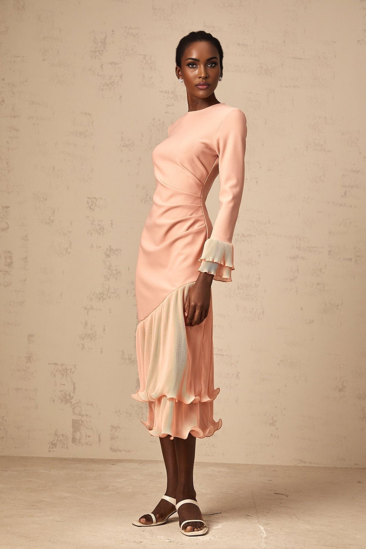 A pink midi dress with ruffled trim and panelled design featuring a flowy silhouette and feminine details