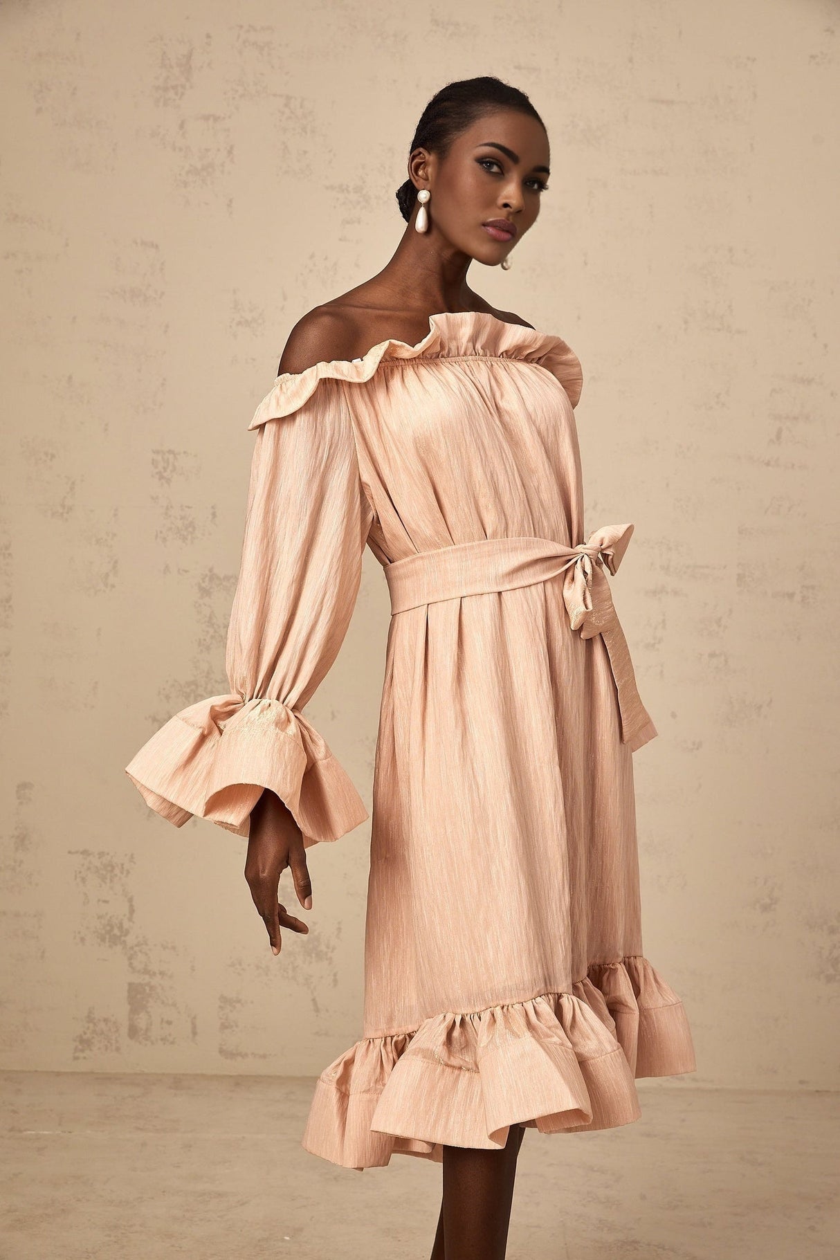 A pink midi dress with ruffles and a tied waist detail named Agathe