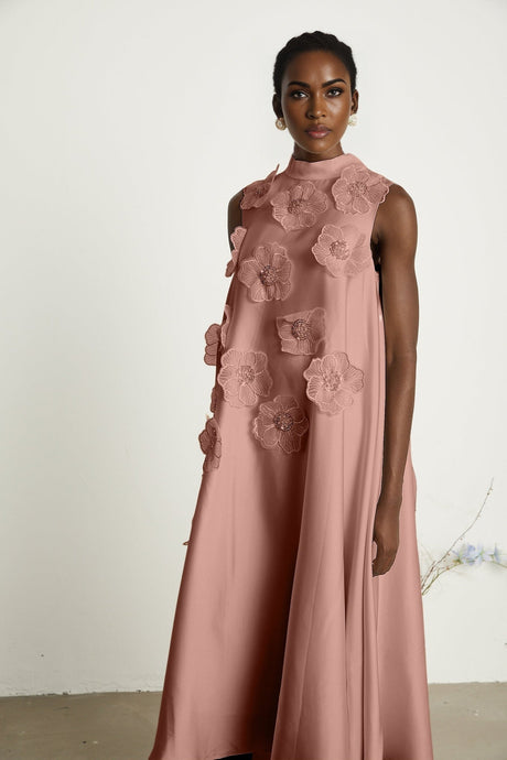 A pink sleeveless midi dress with floral applique details named Emilie