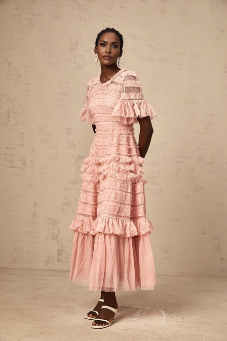A pink tulle midi dress with ruffles and small dot details named Aimee