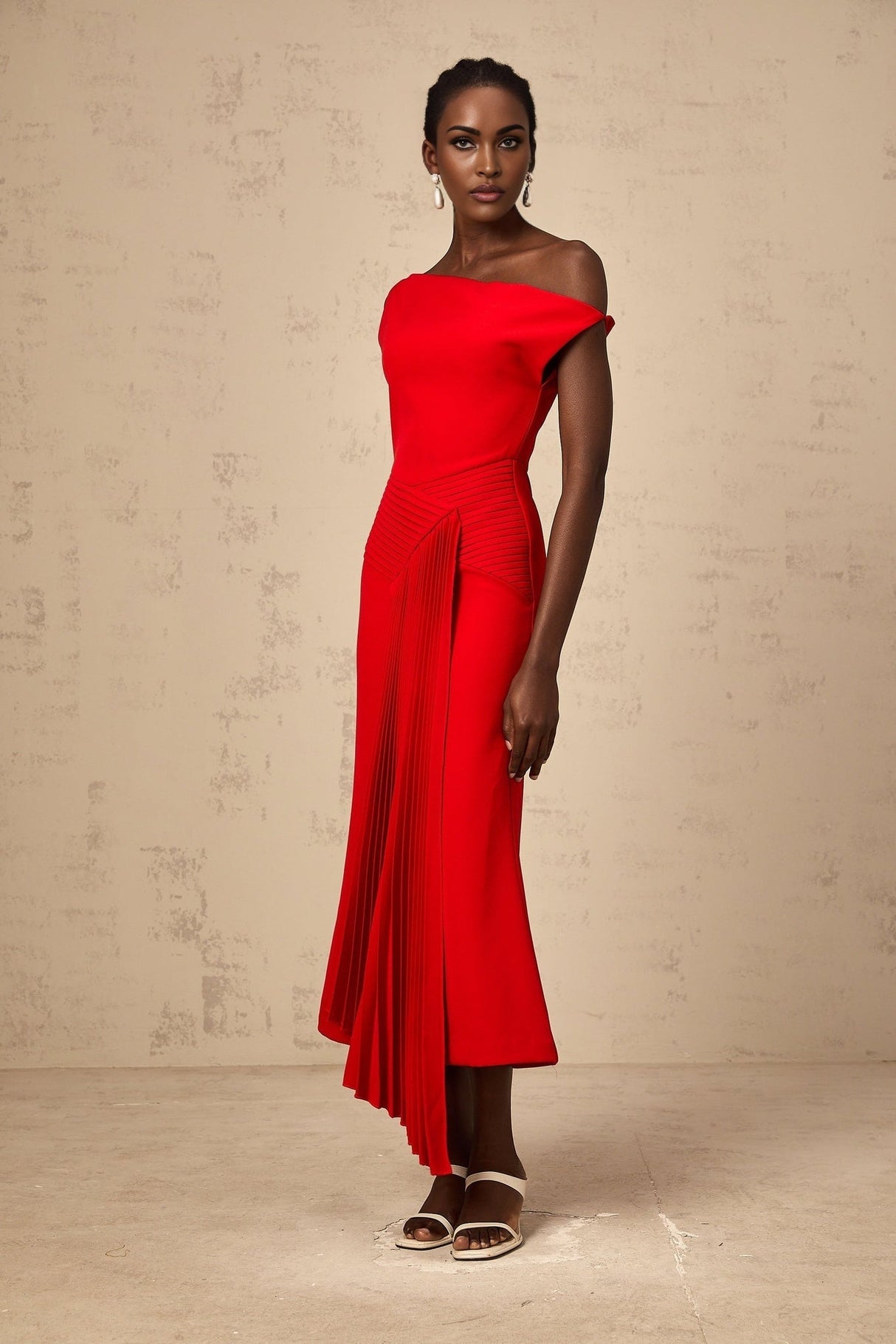 A red asymmetric draped midi dress with a flowing silhouette named Laurine