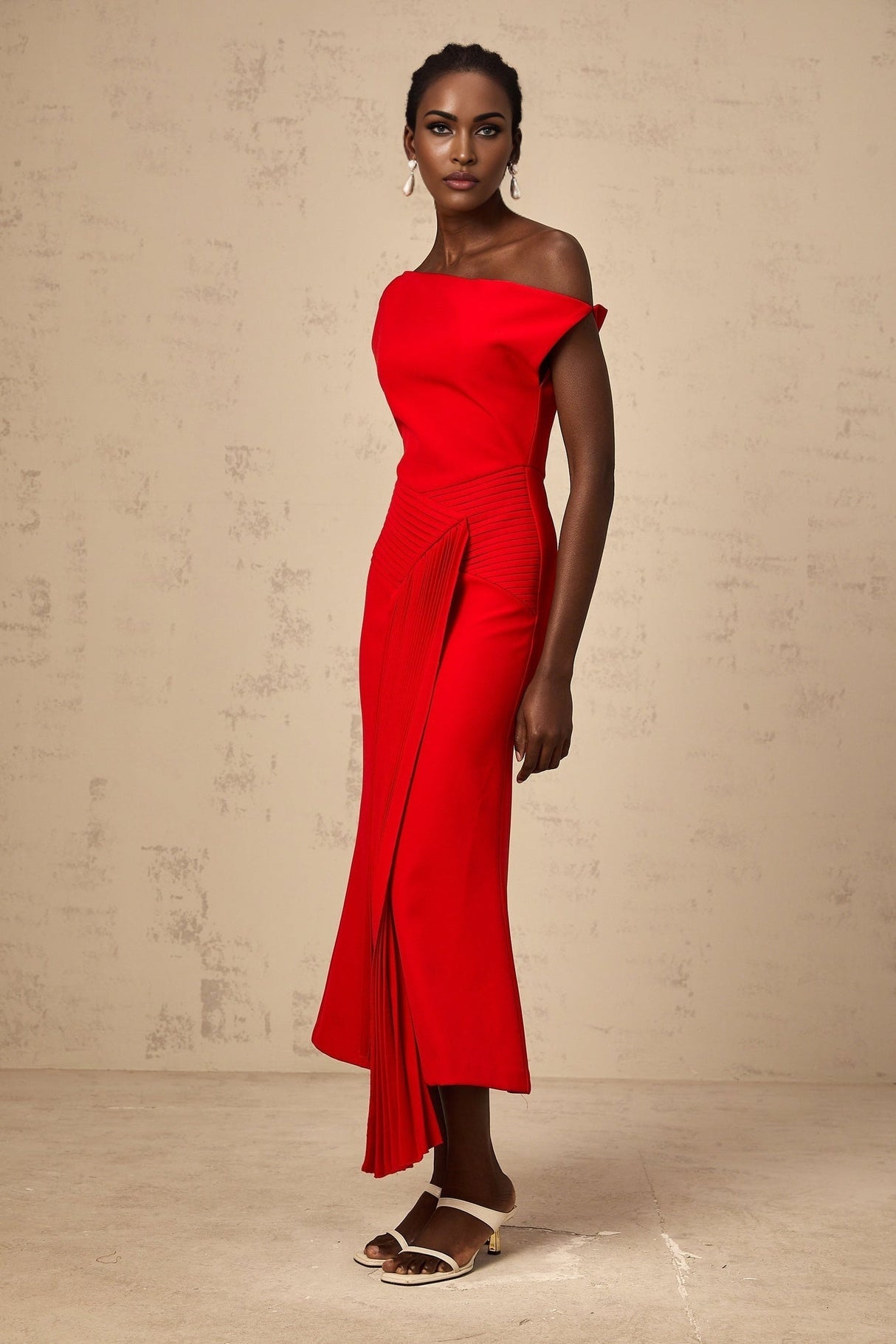 A red asymmetric midi dress with draped details named Laurine featuring an uneven hemline and flowing fabric