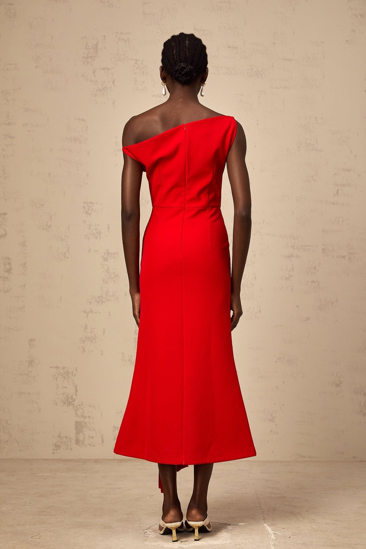 A red asymmetric midi dress with draped fabric design named Laurine