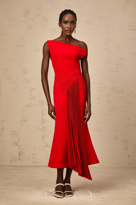 A red asymmetric midi dress with draped fabric details and an uneven hemline worn by a model against a plain background