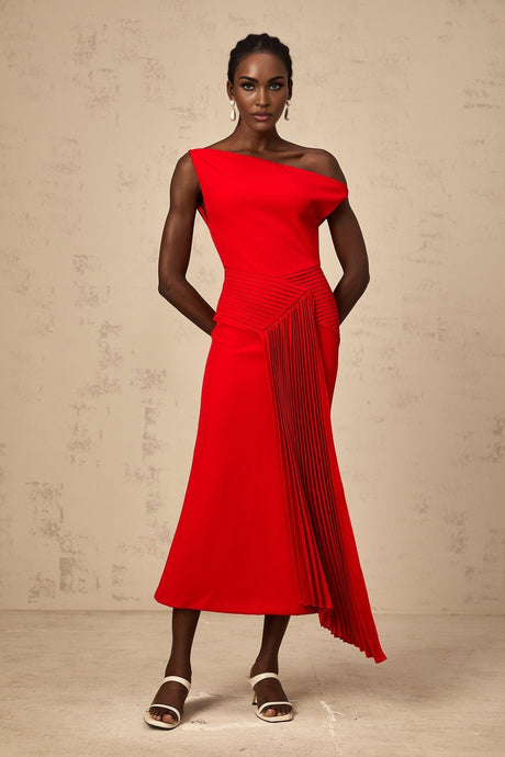 A red asymmetric midi dress with draped fabric details worn by a model standing against a plain background