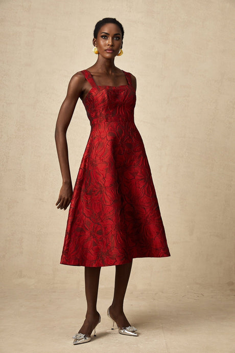 A red midi dress with a floral jacquard pattern featuring a fitted silhouette and feminine design